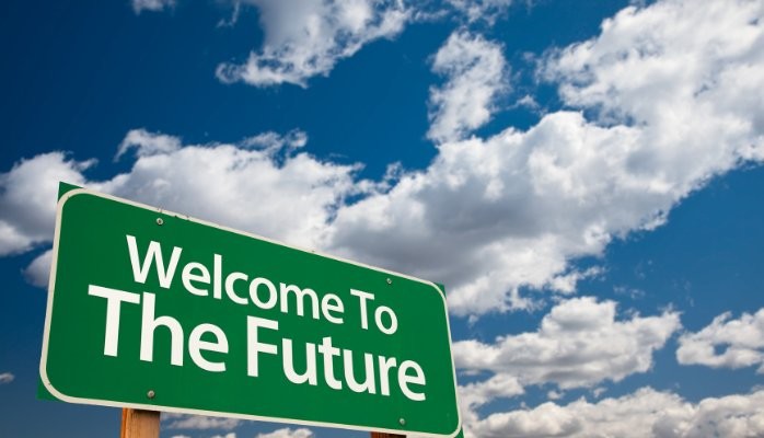 Green road sign welcome to the future with clouds above