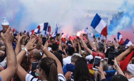 Group of people cheering with French flags