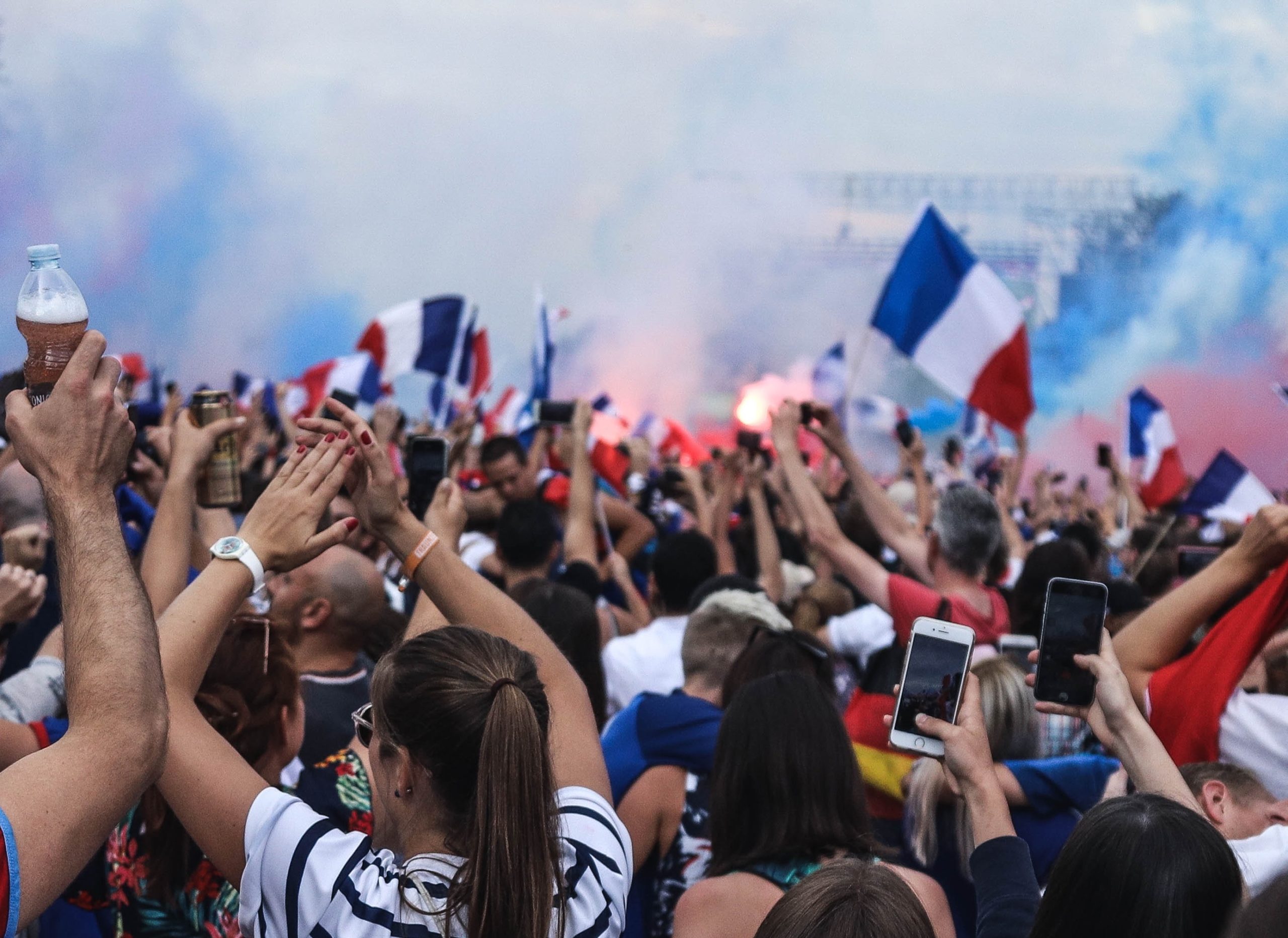 Group of people cheering with French flags